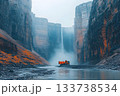 Excavator operating in a deep rocky canyon with mist and a tall waterfall 133738534