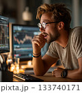 Man Analyzing Financial Data on Computer at Night  133740171