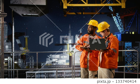 Environmental engineers on offshore platform conduct inspections, monitor oil rig petroleum extraction to ensure efficient drilling operations within the marine oil industry. Environmental engineers on offshore platform conduct inspections, monitor oil rig petroleum extraction to ensure efficient drilling operations within the marine oil industry. 133740414