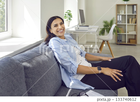 Portrait of a relaxed african american woman sitting on sofa at home with closed eyes. Portrait of a relaxed african american woman sitting on sofa at home with closed eyes. 133740612