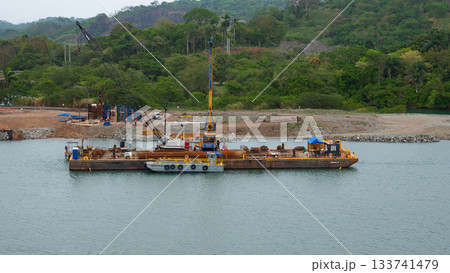 Colon, Panama - May 06, 2019: Water load transportation of barge on river. Cargo barge transport Colon, Panama - May 06, 2019: Water load transportation of barge on river. Cargo barge transport 133741479