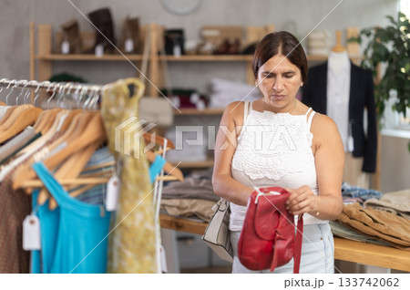 Woman view assortment in clothing department, buying lady handbag Woman view assortment in clothing department, buying lady handbag 133742062