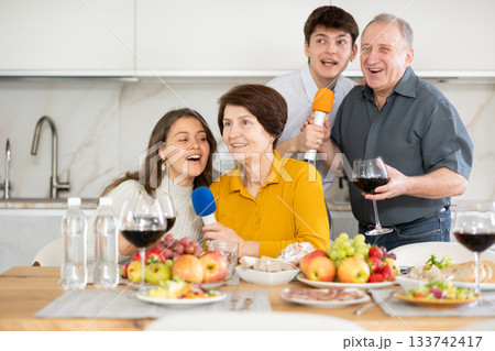 Parents sing karaoke with children while celebrating birthday Parents sing karaoke with children while celebrating birthday 133742417