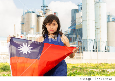 Sad young woman with flag of Taiwan against background of factory Sad young woman with flag of Taiwan against background of factory 133742658