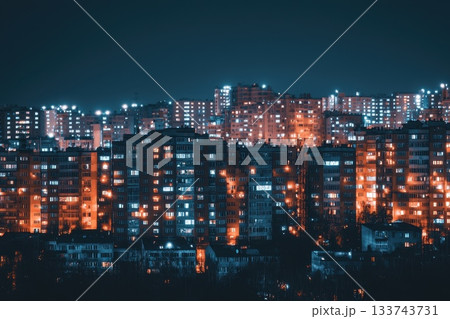 A city skyline at night with many buildings lit up A city skyline at night with many buildings lit up 133743731
