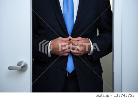 A man in a suit is getting ready to leave the room 133743753