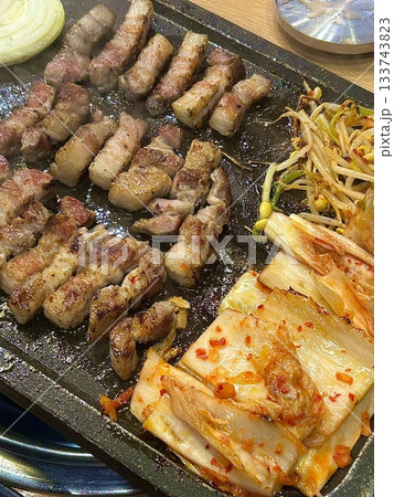 Juicy grilled samgyeopsal paired with savory mushrooms and tangy, sizzling kimchi, creating a perfect balance of rich, earthy, and spicy flavors in every delicious, mouthwatering bite. Juicy grilled samgyeopsal paired with savory mushrooms and tangy, sizzling kimchi, creating a perfect balance of rich, earthy, and spicy flavors in every delicious, mouthwatering bite. 133743823