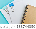 ノートと書類とデスクワークのイメージ 133744350
