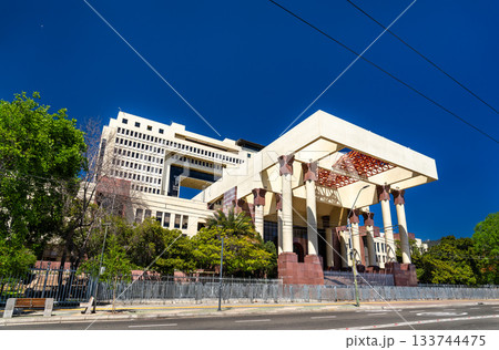 View of the National Congress of Chile building in Valparaiso. The massive modern government structure features large columns and a wide entrance under a deep blue sky View of the National Congress of Chile building in Valparaiso. The massive modern government structure features large columns and a wide entrance under a deep blue sky 133744475