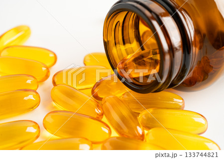 Fish oil Omega 3 capsules vitamin with EPA and DHA isolated on white background. Fish oil Omega 3 capsules vitamin with EPA and DHA isolated on white background. 133744821
