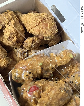 Crispy fried chicken with golden, crunchy skin and juicy, tender meat. A delicious and savory dish, perfect for any meal, served with dipping sauces or side dishes for extra flavor! 133744975