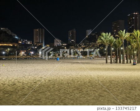 beach scene glow, sandy beach with city lights, palm trees by sandy shore and vibrant city skyline beach scene glow, sandy beach with city lights, palm trees by sandy shore and vibrant city skyline 133745217