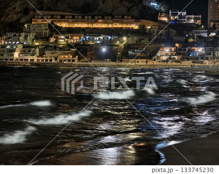 night city lights, urban night waves scene, night shoreline reflecting city illumination and motion 133745230