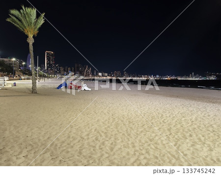 serene night at peaceful coastal campsite, relaxing evening spent camping beside calm ocean waters 133745242