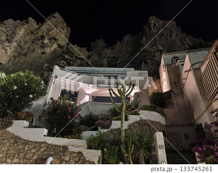 intimate boutique guesthouse ambiance, whimsical guesthouse nestled under rocks with lanternlit 133745261