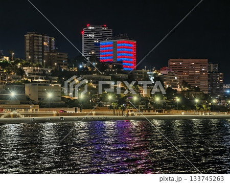 picturesque residential area on hillside illuminated by landmark lights and bustling nightlife 133745263