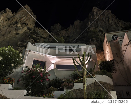 secluded cliffside hideaway at night, luminous secluded cliffside sanctuary adorned with vibrant 133745266