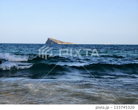 contemplative maritime landscape scene, distant rocky island with textured waves and blue hues contemplative maritime landscape scene, distant rocky island with textured waves and blue hues 133745320