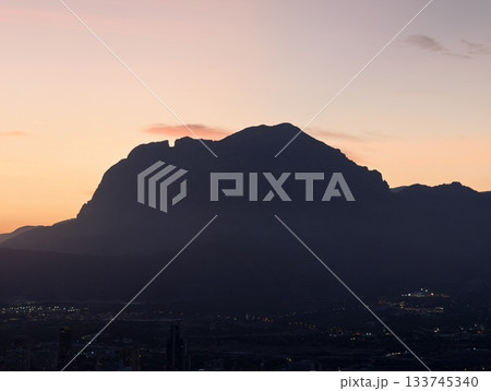 pink mountains and peaceful valley, serene mountain profile at dusk with pastel sky and valley pink mountains and peaceful valley, serene mountain profile at dusk with pastel sky and valley 133745340