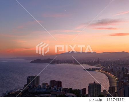 beach sunset serenity, warm sunset over gentle waves, golden hour on sandy shores and city skyline beach sunset serenity, warm sunset over gentle waves, golden hour on sandy shores and city skyline 133745374