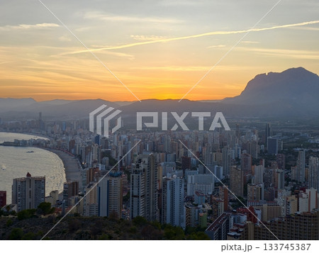 beach sunset scene, breathtaking sunset view of bay with city silhouette and shimmering water beach sunset scene, breathtaking sunset view of bay with city silhouette and shimmering water 133745387