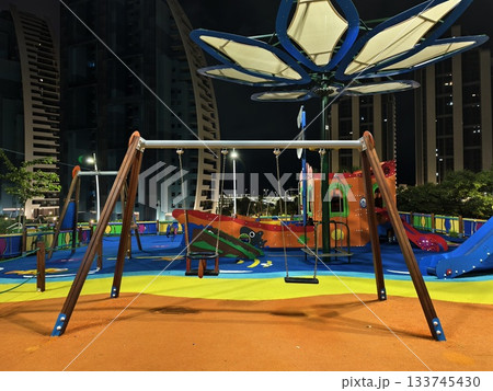 vivid playground surfaces and gentle shadows create inviting atmosphere for evening inspection 133745430