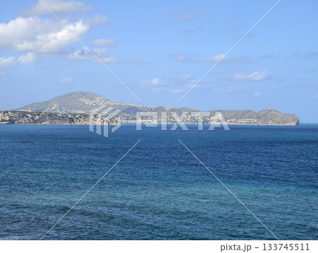 gentle ocean waves and distant silhouettes, peaceful open sea with layered blue tones and distant gentle ocean waves and distant silhouettes, peaceful open sea with layered blue tones and distant 133745511