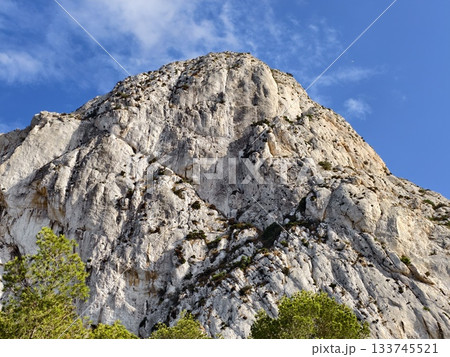 closeup of rocky fissured face, intimate examination of rugged rock formation with mineral closeup of rocky fissured face, intimate examination of rugged rock formation with mineral 133745521