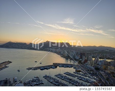 evening sunset casts golden light on peaceful marina with reflective waters and calm atmosphere 133745587