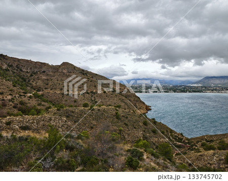 misty city harbor, cloudfilled sea view over city, overcast seaside scene with urban skyline 133745702