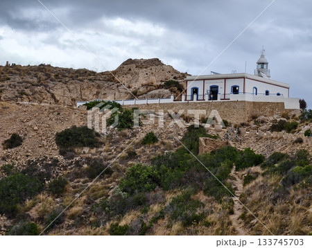 rugged coastal sanctuary with bell tower, serene seaside chapel featuring arched facade and bell rugged coastal sanctuary with bell tower, serene seaside chapel featuring arched facade and bell 133745703