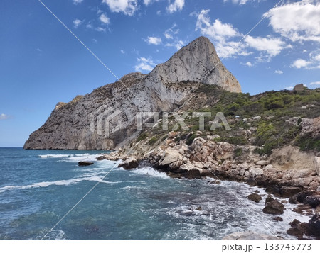 cliff oversea adventure, imposing limestone cliff above lively sea as small boat navigates scenic cliff oversea adventure, imposing limestone cliff above lively sea as small boat navigates scenic 133745773