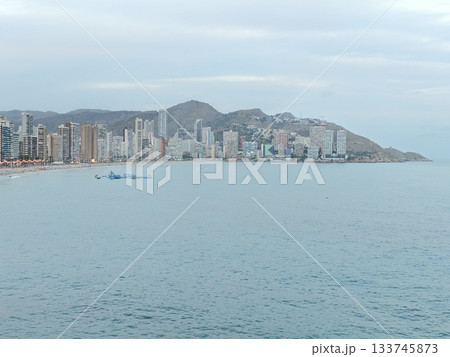 calm coastal morning, serene coastal scene with boats, tranquil coastal dawn with vessels under pale 133745873