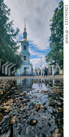 Panoramic view of St. Nicholas Naval Cathedral with high bell tower. Beautiful reflection in water. Nikolo-Bogoyavlenskiy Morskoy Sobor built in 1762 in Saint Petersburg, Russia 133745921
