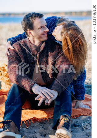 Portrait happy beautiful couple in love enjoying autumn picnic in autumn park. Vertical photo. High quality photo 133746130