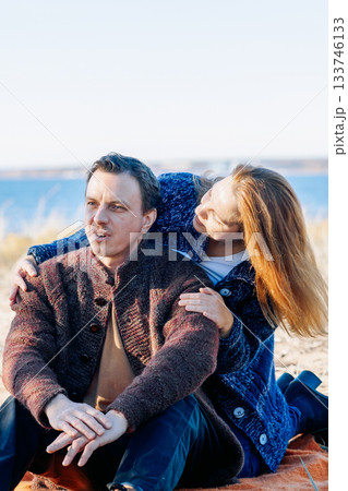 Portrait happy beautiful couple in love enjoying autumn picnic in autumn park. Vertical photo. High quality photo 133746133