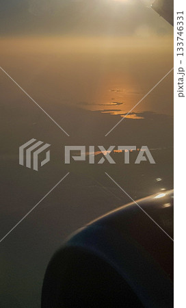 View from airplane porthole to beautiful sunset, blue sky and air clouds. High quality photoView from airplane porthole to beautiful sunset, blue sky and air clouds View from airplane porthole to beautiful sunset, blue sky and air clouds. High quality photoView from airplane porthole to beautiful sunset, blue sky and air clouds 133746331