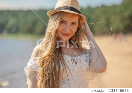 Portrait of girl in beach hat on summer day outdoors. High quality photo 133746638