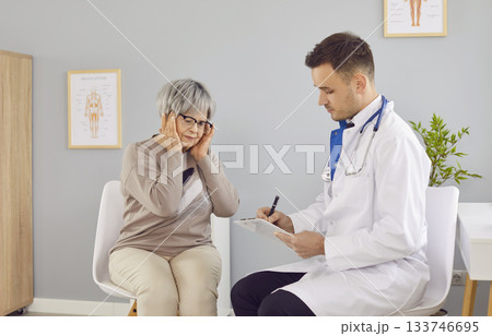 Headache problem complaint to doctor during clinic visit, taking care of old woman Headache problem complaint to doctor during clinic visit, taking care of old woman 133746695
