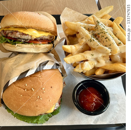 A classic combination of a juicy burger with fresh toppings served alongside golden, crispy French fries. Perfect for a satisfying meal that blends savory flavors and crunchy textures. A classic combination of a juicy burger with fresh toppings served alongside golden, crispy French fries. Perfect for a satisfying meal that blends savory flavors and crunchy textures. 133747635