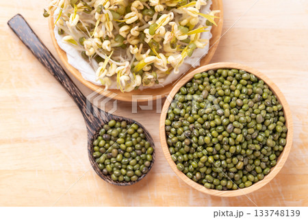 Mung bean seeds and sprouts on wooden background, Food ingredient in Asian cuisine Mung bean seeds and sprouts on wooden background, Food ingredient in Asian cuisine 133748139