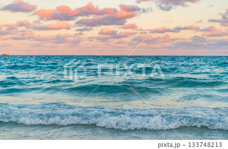 Dramatic sunrise horizon at sea. Romantic summer vacation on sunset seascape. Sea sunset on ocean. Sunset seascape at summer vacation. Sunrise with sea beach Dramatic sunrise horizon at sea. Romantic summer vacation on sunset seascape. Sea sunset on ocean. Sunset seascape at summer vacation. Sunrise with sea beach 133748213