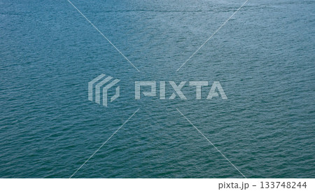 Sea water surface. Ripple water of ocean. Aquamarine ocean nature. Background of clear turquoise sea water. Idyllic summer vacation. Caribbean sea. Aerial view. Rippled surface 133748244