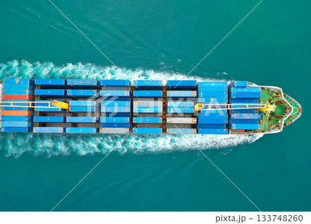 Container ship. Shipping logistics. Commercial shipping. Cargo ship in sea. Freight container loaded on cargo vessel. Aerial view cargo ship entering harbor. Cargo business. Global shipping routes Container ship. Shipping logistics. Commercial shipping. Cargo ship in sea. Freight container loaded on cargo vessel. Aerial view cargo ship entering harbor. Cargo business. Global shipping routes 133748260