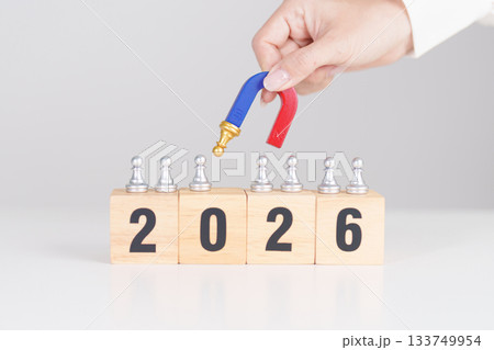 hand holding magnet and pulling man chess figure from the crowd employee with 2026 Year block. Human resource management, Recruitment, Teamwork, strategy, toxic people and leadership Concepts hand holding magnet and pulling man chess figure from the crowd employee with 2026 Year block. Human resource management, Recruitment, Teamwork, strategy, toxic people and leadership Concepts 133749954