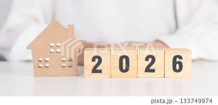 Happy New Year 2026 with house model. real estate, Home loan and mortgage, tax, investment, financial, savings and New Year Resolution concepts 133749974