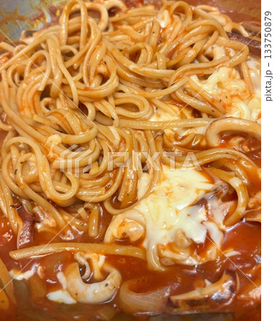 Classic spaghetti coated in rich tomato sauce, offering a simple yet delicious combination of tangy, savory flavors perfect for a comforting meal. 133750879