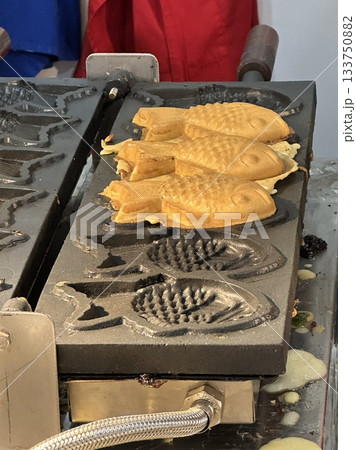 Bungeoppang, bungeo-ppang (Korean Fish Shaped Pastry), popular snack, cookies, sweet in winter streets of Korea. Bungeoppang Korean traditional national food, dish, cuisine. Japanese taiyaki Bungeoppang, bungeo-ppang (Korean Fish Shaped Pastry), popular snack, cookies, sweet in winter streets of Korea. Bungeoppang Korean traditional national food, dish, cuisine. Japanese taiyaki 133750882