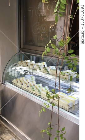 Beautiful and delicious pastries displayed in a bakery, with colorful glazes, delicate toppings, and tempting textures. Offering a perfect visual feast of sweetness and artisanal charm. 133751091