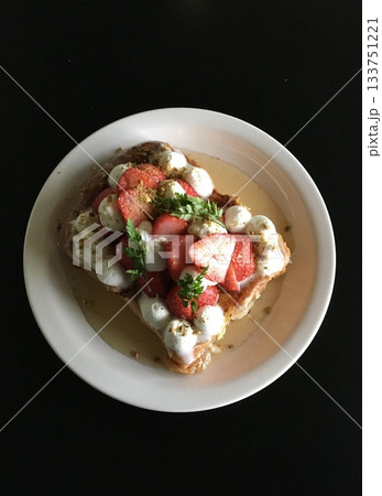A delectable slice of cake with rich layers of cream and frosting, topped with fresh fruit or sprinkles. Perfect for dessert photography, showcasing indulgence and sweetness in food-related projects. 133751221
